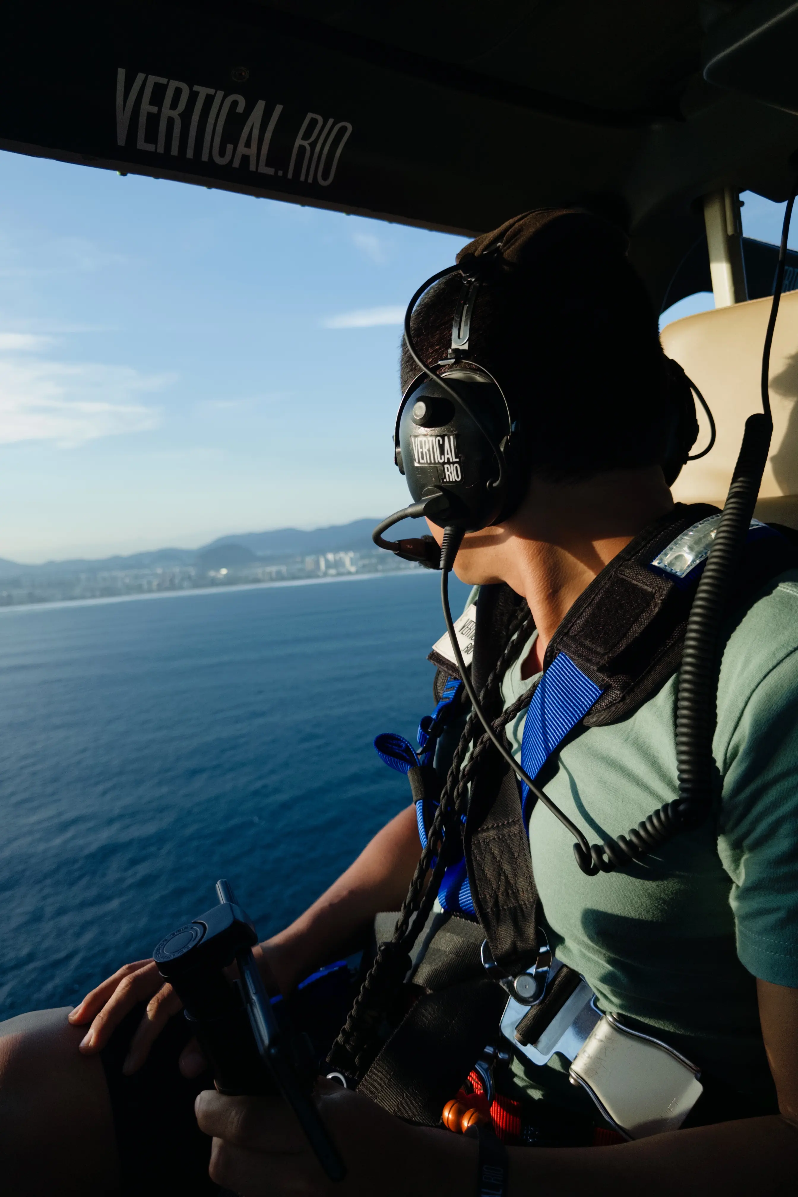 Passenger adjusting lightweight clothing before boarding a Vertical Rio helicopter tour